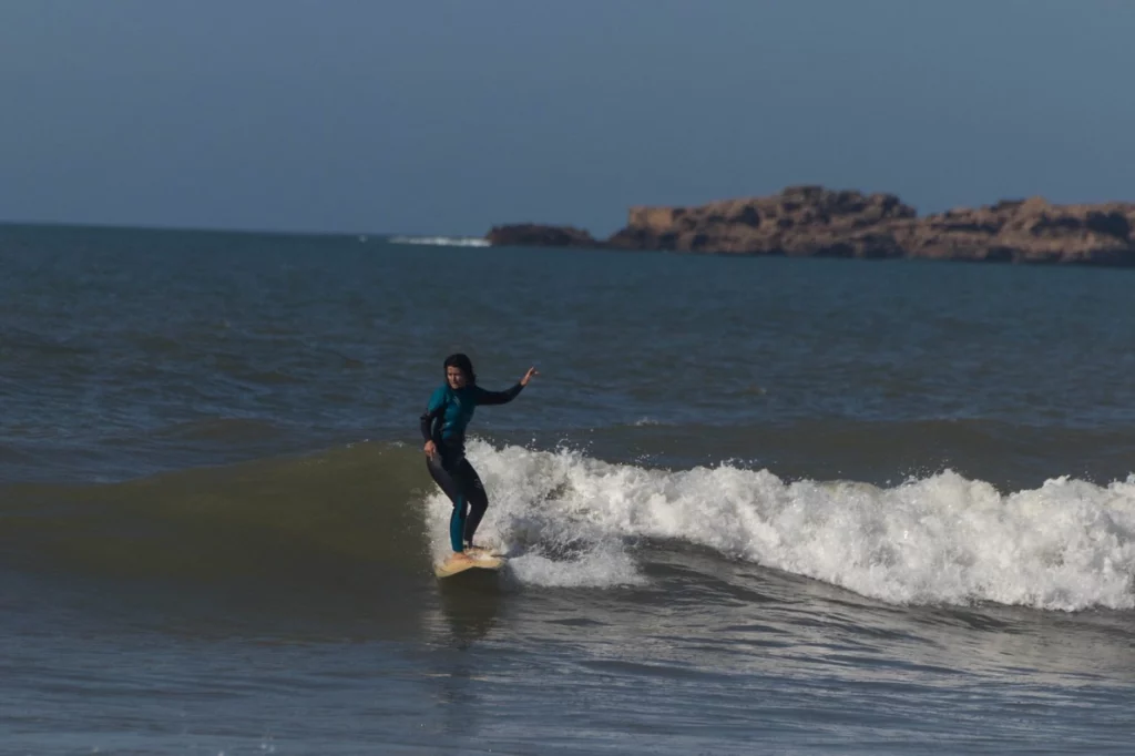 a lady surfing in the waves of Essaouira beach